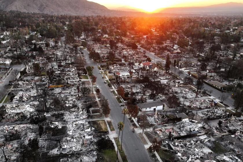ALTADENA, CALIFORNIA - JANUARY 21: An aerial view of the sun rising above homes that burned in the Eaton Fire on January 21, 2025 in Altadena, California. Multiple wildfires which were fueled by intense Santa Ana Winds have burned across Los Angeles County leaving at least 27 dead with over 180,000 people having been under evacuation orders. Over 12,000 structures, many of them homes and businesses, burned in the Palisades and Eaton Fires. Newly inaugurated President Donald Trump plans to visit 
