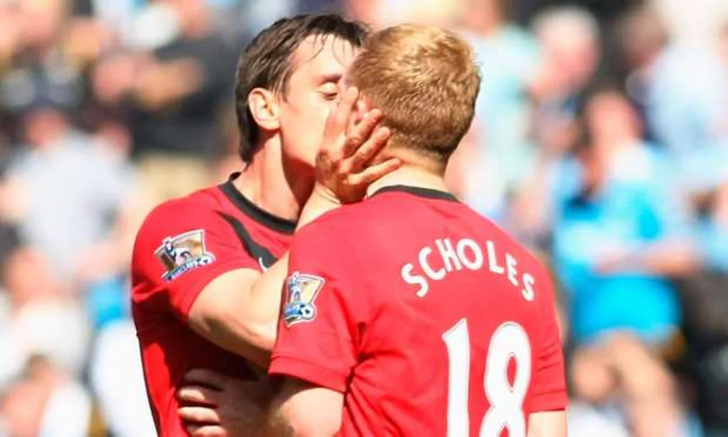 SMACKER: Gary Neville shows his appreciation to Paul Scholes after derby success