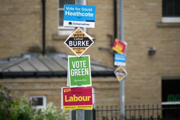 Local election campaign posters from the major political parties adorn a lamp post ahead of tomorrow's voting on May 4, 2022 in Huddersfield, England.