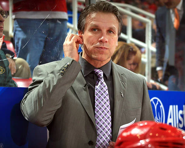 Assistant coach Jim Hiller of the Detroit Red Wings watches the play from the bench against the Pittsburgh Penguins during a NHL game on October 23,...