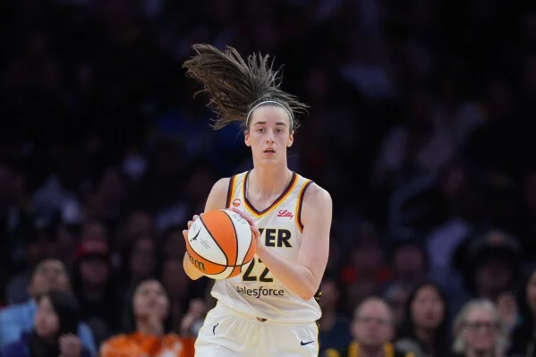 Indiana Fever guard Caitlin Clark (22) dribbles during the first half of a WNBA basketball game against the Los Angeles Sparks Wednesday, May 13, 2026, in Los Angeles. (AP Photo/Jae C. Hong)