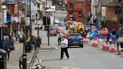 Reuters People walk along the high street ahead of the Makerfield by-election.