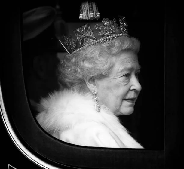 Queen Elizabeth II travels down The Mall, from Buckingham Palace to the Palace of Westminster, in the horse drawn Irish State Coach to attend the...