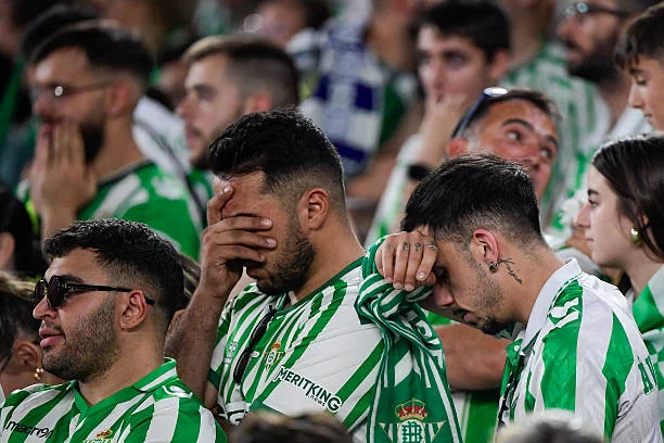 Real Betis supporters react while watching the UEFA Conference League final between Real Betis and Chelsea FC in Wroclaw, displayed on a giant screen...