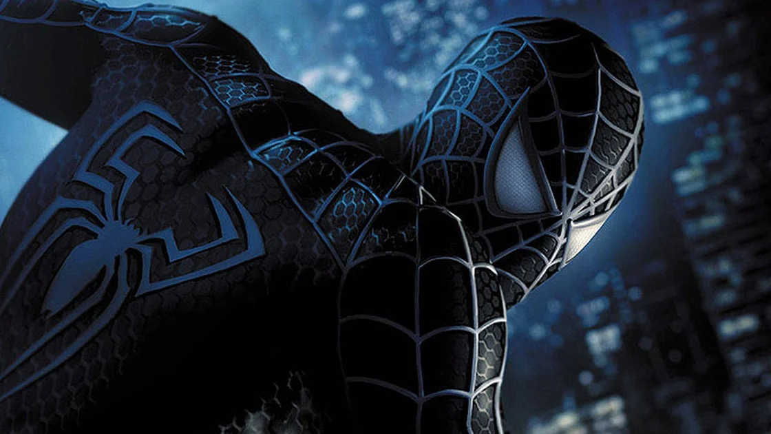 Spider-Man in black suit crouching against a glowing city at night. — Spider Man Picture