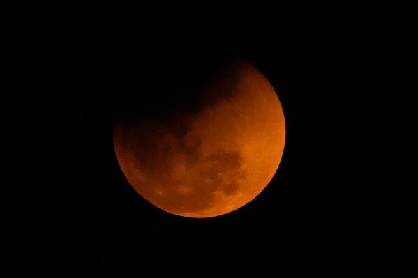 The blood moon is seen shortly after a total lunar eclipse in Guwahati, India, Tuesday, March 3, 2026. (AP Photo/Anupam Nath)