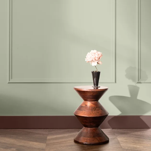 A serene living room with sage walls, soft lighting, and modern furniture; dulux chooses soulful.