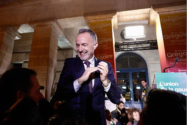 Socialistes et Apparentes' MP and Paris' Mayoral candidate Emmanuel Gregoire acknowledges supporters after his victory following the announcement of...