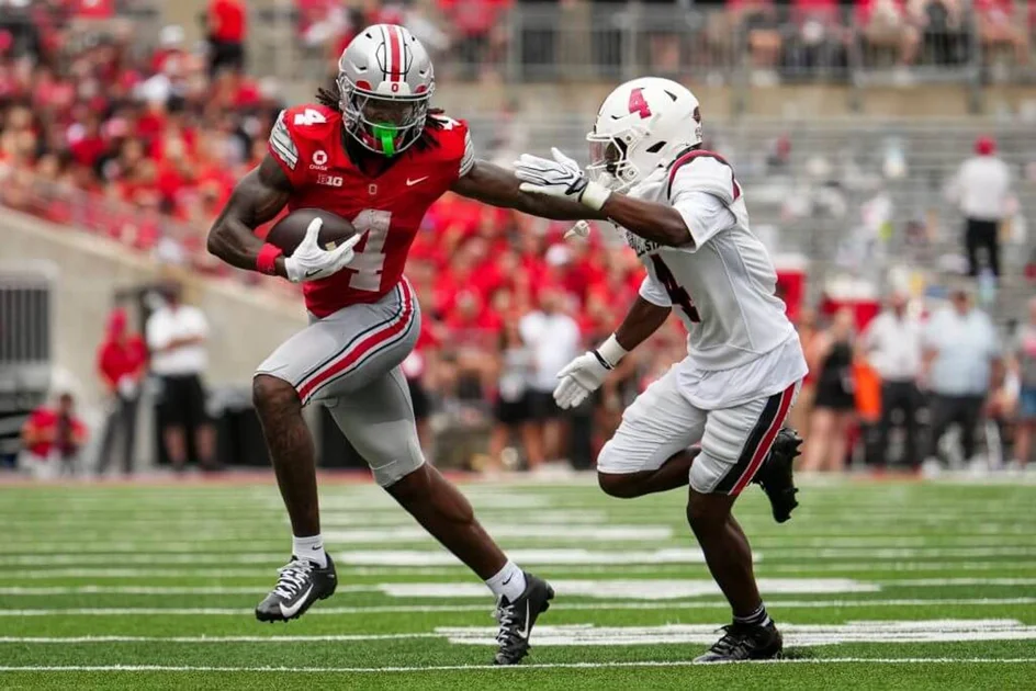 Ohio State wide receiver Jeremiah Smith runs past Ball State defensive back Willizhuan Yates.