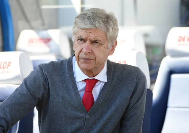 Arsene Wenger the Arsenal Manager waves to the fans before the Premier League match between Huddersfield Town and Arsenal at John Smith's Stadium on...